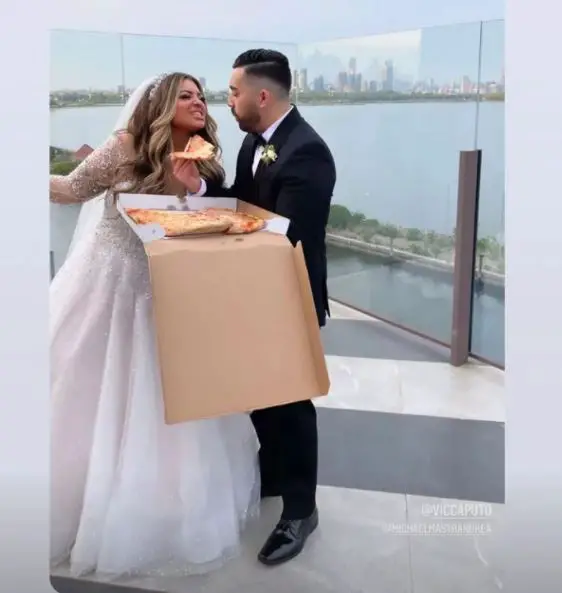 Michael-Mastrandrea-and-Victoria-Caputo-eat-pizza-on-wedding